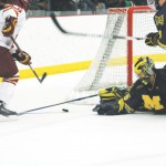 Go for the Gold: Senior Casey Haines (#6) shoots for the goal during Saturday’s game against the Michigan Wolverines. Haines made the first goal of the game, shooting the puck right over the goalie, and the Bulldogs went on to win the game 3-2. Photo By: Kate Dupon | Photo Editor