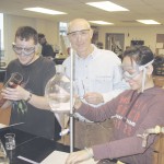 Back at the Lab: Professor Bill Killian assists students Scott Ferris and Hieu-Hanh Phan with their chemistry experiment. Photo By: Kristyn Sonnenberg | Photo Editor