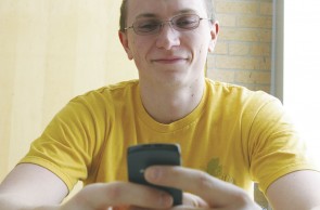 Making the Connection: Steve Linebaugh, a Ferris senior, adds contacts to his very first cell phone. Friends are pleased that they can now call Linebaugh, though his move was also motivated by the need to communicate with potential employers. Photo By: Kristyn Sonnenberg | Photo Editor