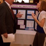 Showcasing Knowledge: An honors senior talks to a guest professor. Honors seniors showcased what they learned in their major over their years at Ferris State. Photo By: Brock Copus | Web Editor