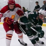 Entering the WCHA: Kyle Bonis, junior left wing, pushes past a Michigan State player during a 2010-11 season game. The Bulldogs will join the WCHA conference beginning in 2013. Torch File Photo