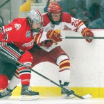Down for the Count: Sophomore center Dom Panetta gets checked into the boards against Ohio State during a game at Ewigleben Ice Arena. The Bulldogs were unsuccessful on the road to come out on top of a three-game series to earn a spot for the CCHA Championship. Photo By: Brock Copus | Multimedia Editor