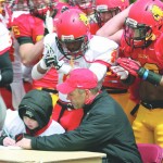 Bulldog Pup: Head coach Tony Annese sits down with cancer survivor Keegan Bulk as he signs his letter of intent at the annual Crimson and Gold Spring Football Game. Photo By: Brock Copus | Multimedia Editor